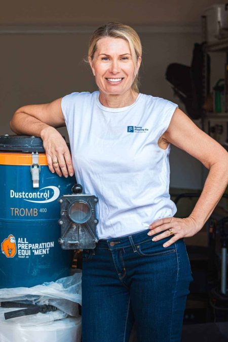 Epoxy Flooring Co team member standing beside a floor grinding dust extractor