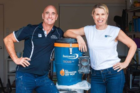 Epoxy Flooring Co team standing beside their floor grinding dust extractor