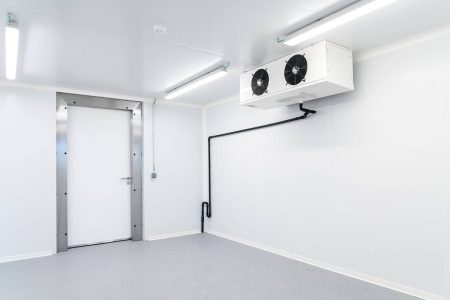 Empty coolroom with refrigeration fans and grey epoxy flooring