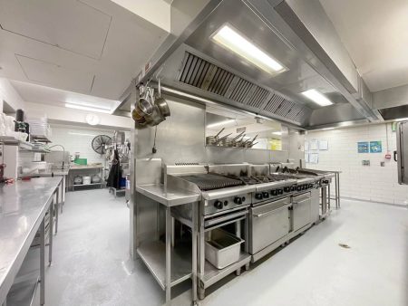 Commercial kitchen with stainless steel benches and epoxy flooring