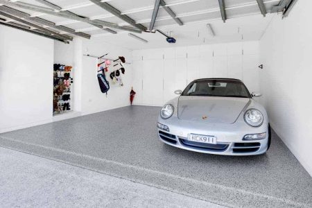Silver Porsche on a glossy Hastings epoxy flake garage floor
