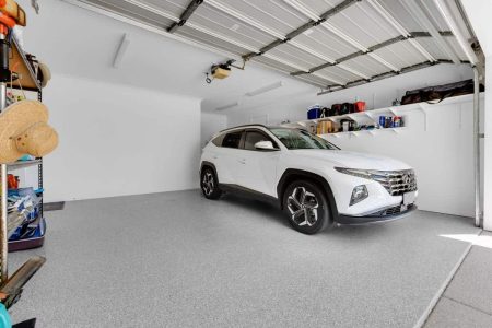 White SUV in a double garage with Laguna Waters epoxy flake flooring