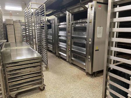 Commercial bakery ovens and racks on epoxy flake flooring