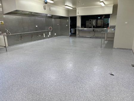 Commercial kitchen with grey epoxy flake flooring