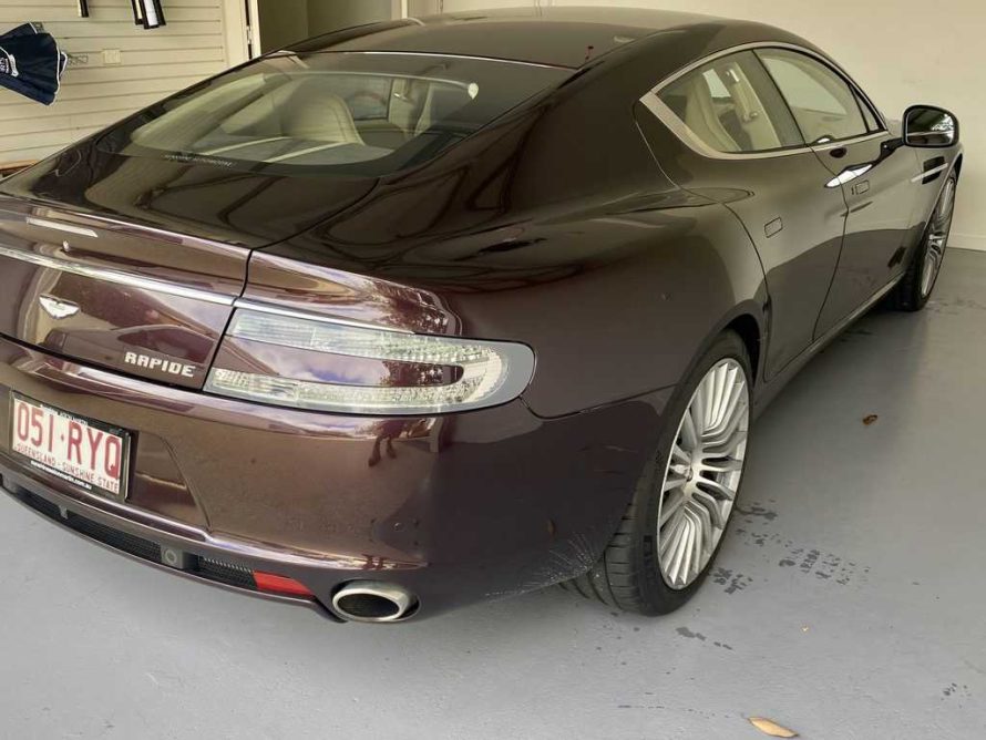 Luxury car parked on a garage floor coating affected by hot tyre pick up