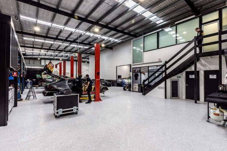 Workshop epoxy flake flooring below a mezzanine office