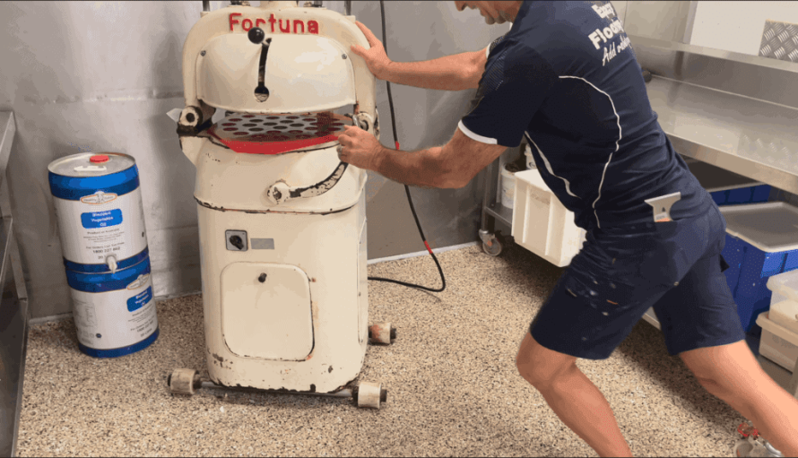 Dragging a heavy dough baller across an epoxy floor to test for scratches