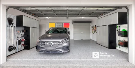 Silver car in a fitted out garage with Nero Grey epoxy flake flooring