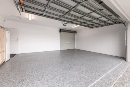 Empty double garage with Nero Grey epoxy flake flooring