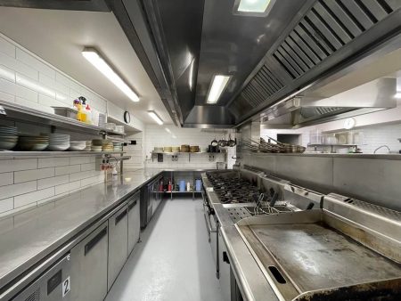 Commercial kitchen cooking line with hygienic epoxy flooring
