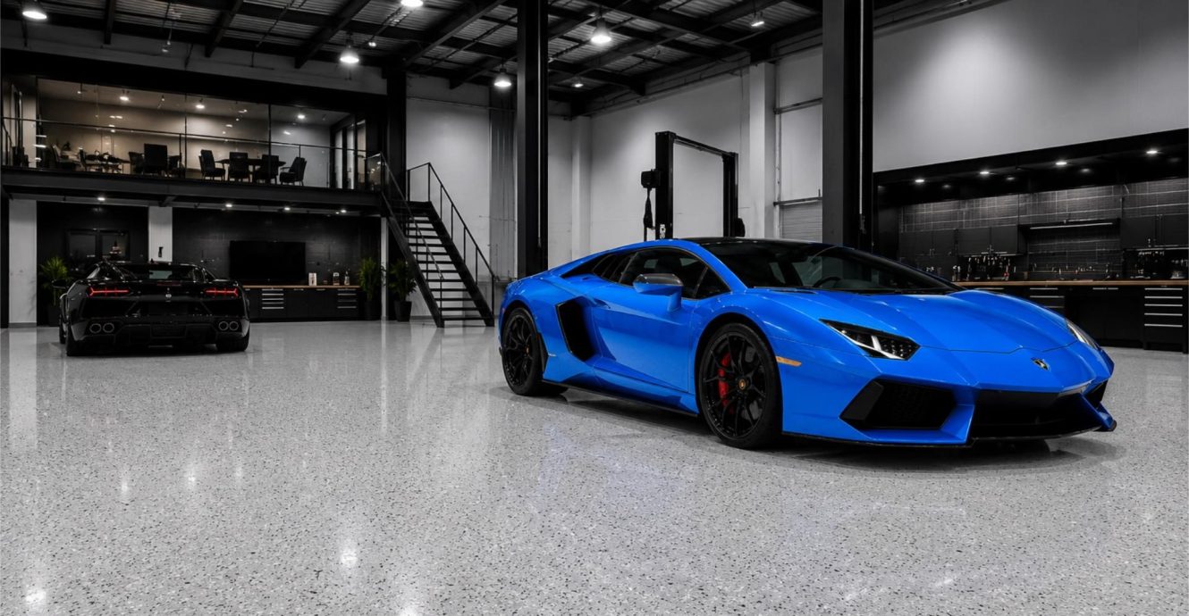 Light grey epoxy flake floor in a car showroom workshop with a blue sports car